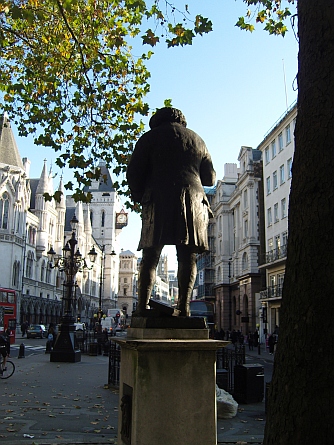 Statue of Johnson outside St Clement Danes church looking down Fleet Street past the Royal Courts of Justice